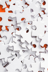 close up of incomplete white jigsaw puzzle pieces
