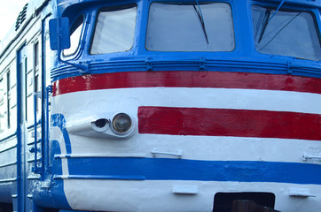 Old soviet electric train with outdated design moving by rail