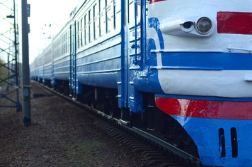Old soviet electric train with outdated design moving by rail