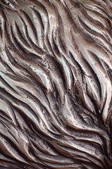 Details and decorative bas-relief ornament from metal of forged stamping iron gate as background...