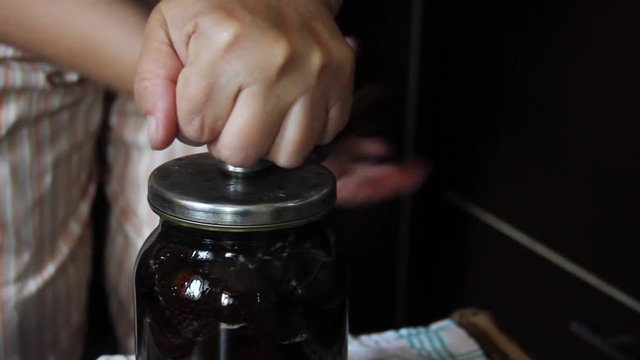 Preparation of strawberry jam. Cook jam. roll up strawberry jam jars using a seamer or a sealer key