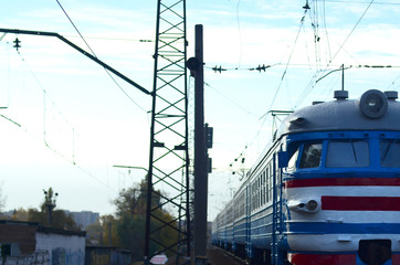 Old soviet electric train with outdated design moving by rail