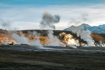 Hot spring at El Tatio Geysers with steaming geysers, hot springs, boiling water all around at sunrise, Chile, South America