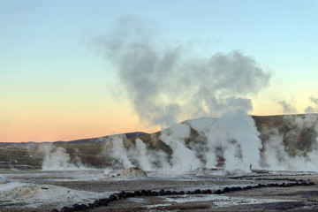 Hot spring at El Tatio Geysers with steaming geysers, hot springs, boiling water all around at sunrise, Chile, South America