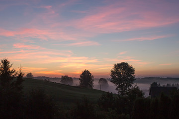 landscape in the fog at dawn on a sunny morning