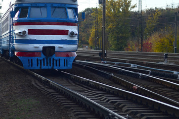 Old soviet electric train with outdated design moving by rail