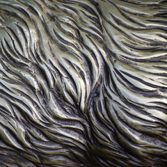 Details and decorative bas-relief ornament from metal of forged stamping iron gate as background...
