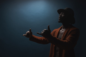 Portrait of male singer in hat and coat. Artist, performer