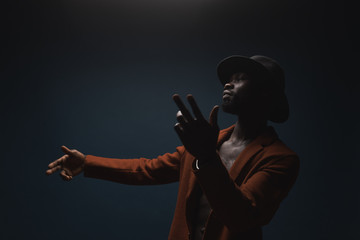 Portrait of male singer in hat and coat. Artist, performer