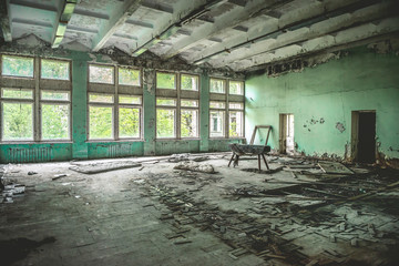 ruined school gym with sports equipment remains in Pripyat