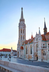 Fototapeta na wymiar Saint Matthias church and tower in Budapest, Hungary. Morning sunrise sky and deserted area.