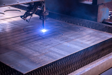 Fototapeta na wymiar Mechanical factory workshop mechanical equipment circular cake shaped steel plate cutting