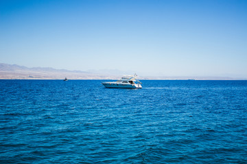white yacht in the Red sea nature environment surrounded by blue smooth water surface, cruise summer vacation concept 