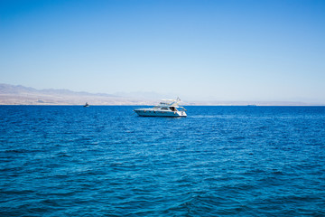white yacht in the Red sea nature environment surrounded by blue smooth water surface, cruise summer vacation concept 