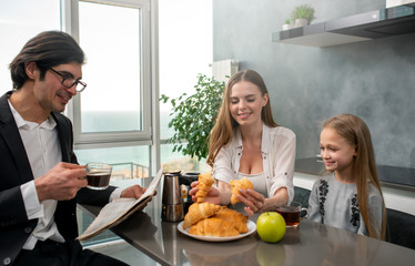 Obraz na płótnie Canvas Happy family have a breakfast at home