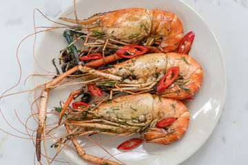Fried king prawns with garlic and herbs, close up, Thailand