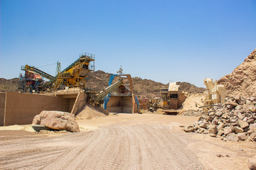 poor factory iron rusty digging machines and industrial production lines in dry desert nature...