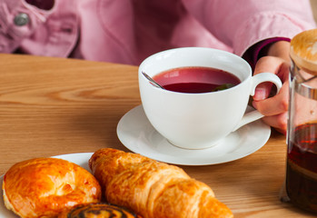 Red herbal tea in a big white cup.