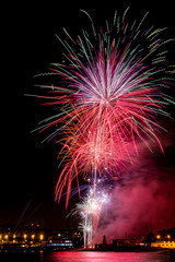 fireworks at night next to the beach