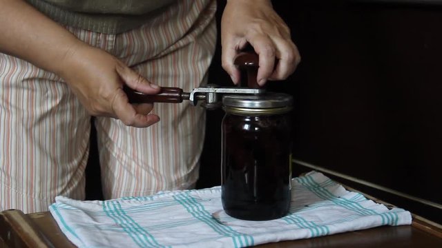 Preparation of strawberry jam. Cook jam. roll up strawberry jam jars using a seamer or a sealer key