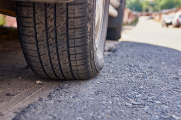 Close-up of a car tire on the asphalt. Small DOF.