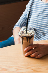 Chocolate milkshake in a jur with straw.