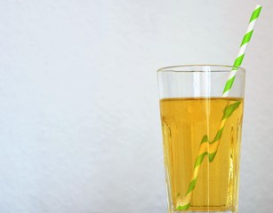 paper tube for drinking in a glass with apple juice