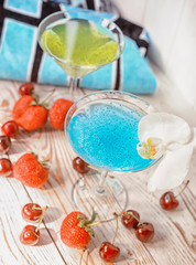 Useful refreshing drinks with chia and basil seeds, fruit and beach towel. Bright rest of the world.