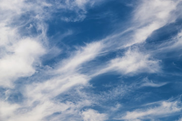 Unusual shape small fluffy clouds in the blue sky