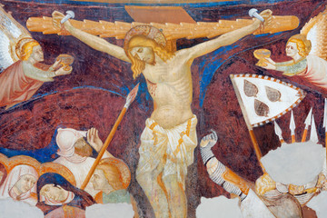 COMO, ITALY - MAY 9, 2015: The old fresco of Crucifiction in church Basilica di San Abbondio by unknown artist "Maestro di Sant'Abbondio" (1315 - 1324).