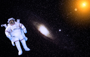 Obraz na płótnie Canvas Astronaut and Milky way. Galaxy and stars. Sun flare. Elements furnished by NASA.