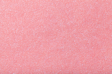 Texture of old pink paper background, closeup. Structure of dense rose cardboard.