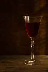 glass of red wine on black background