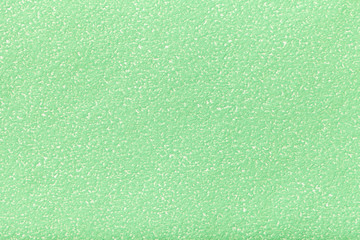 Texture of old light green paper closeup. Structure of a dense cardboard. The olive background.