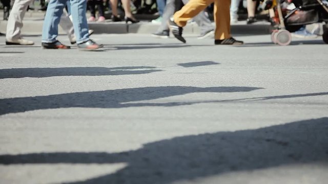 Closeup view of human feet people walking on crowded street. Legs of Crowd People Walking on the Street.