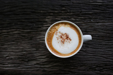 cup of coffee on dark antique wooden background