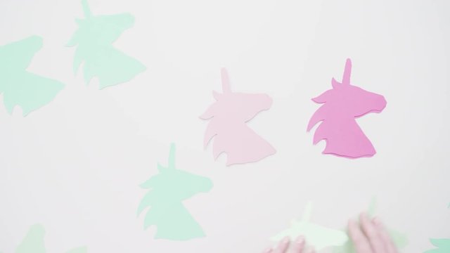 Flat lay. Colorful unicorn paper cutouts on a white background.