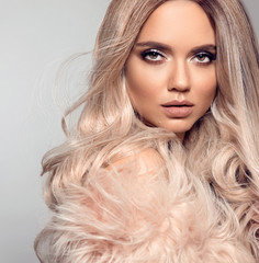 Ombre blond hairstyle. Beauty fashion blonde portrait. Sexy woman wears in pink fur coat. Beautiful...