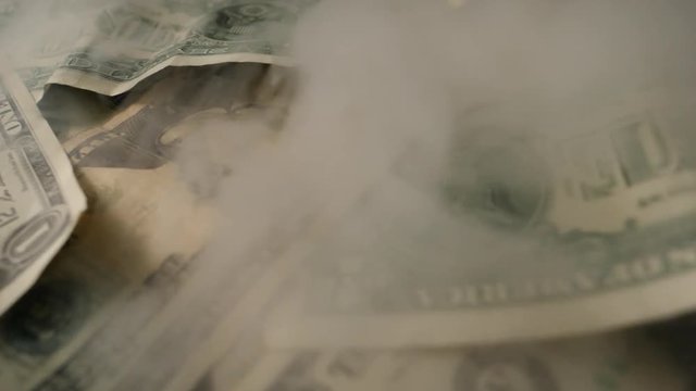 Smoke Over Dollar bills in a box, money background. Dollars money set Slow With Shallow Dof and smoke. Dollars, money close up.