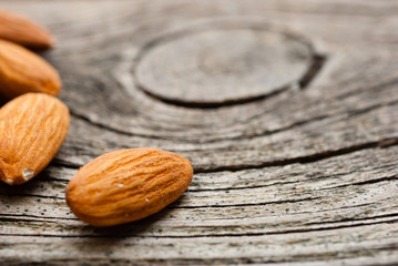 peeled almonds on old wood table