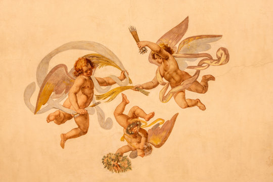 COMO, ITALY - MAY 11, 2015: The detail of baroque fresco of angels with the  instruments of martyrium in church Chiesa di San Orsola Gian Domenico Caresana (1616).