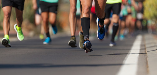 Marathon running race, people feet on city road