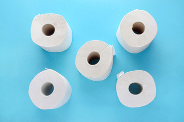 white toilet paper rolls on blue background