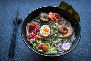 Bowl of Japanese buckwheat ramen noodle soup with colorful toppings spelling out 2019 in pickled ginger, boiled egg, edamame beans, and shrimp