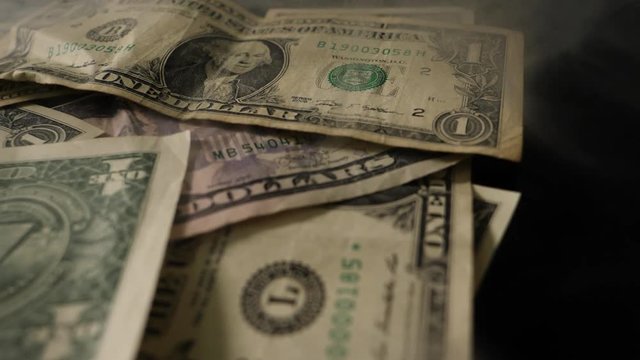 Smoke Over Dollar bills, money background. Dollars money set Slow With Shallow Dof and smoke. Dollars, money close up.