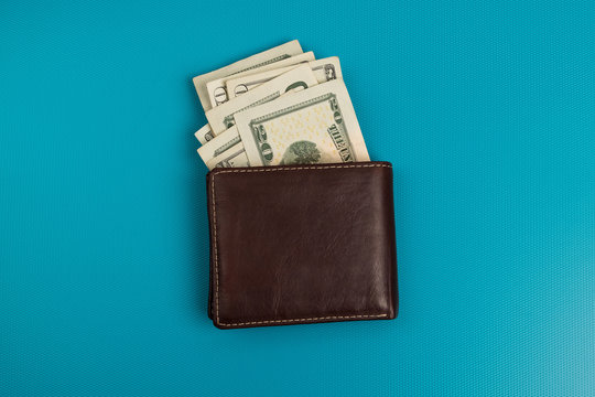 Male wallet with banknotes studio image. Leather wallet with dollar bills.