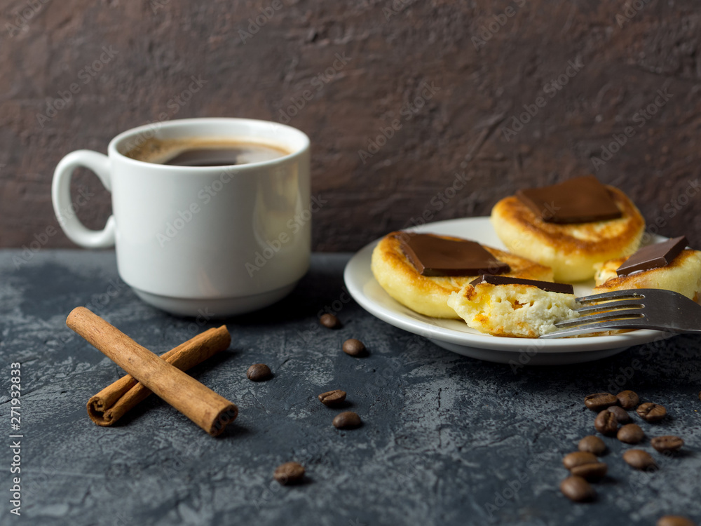 Wall mural white cup of espresso and cheese pancakes with bitter chocolate