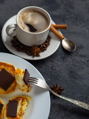 white Cup of espresso and cheese pancakes with bitter chocolate