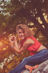 Woman holding heart shape and enjoying the sunset/sunrise.