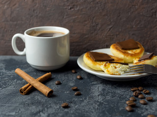 white Cup of espresso and cheese pancakes with bitter chocolate